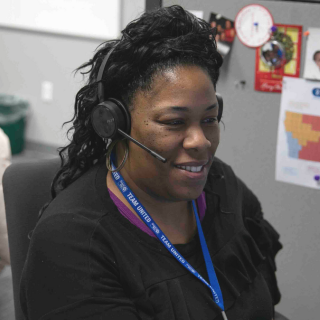 Woman with headset in workspace.